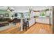 Open-concept kitchen with white cabinetry, stainless steel appliances, and a breakfast bar overlooking the living area at 3304 W Harbor View Ave, Tampa, FL 33611