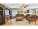 Comfortable living room with hardwood floors, large TV, and cozy seating arrangement at 3304 W Harbor View Ave, Tampa, FL 33611