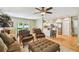 Open-concept living area with hardwood floors, comfortable seating, and access to the kitchen at 3304 W Harbor View Ave, Tampa, FL 33611