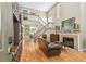 Elegant living room with hardwood floors, a cozy fireplace, and a staircase leading to the second floor at 3304 W Harbor View Ave, Tampa, FL 33611