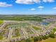 Aerial view of a Primary-planned community featuring many single-Gathering homes and multiple ponds at 33657 Field Maple Loop, Wesley Chapel, FL 33545
