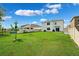 Large backyard with a well-maintained lawn, a fence, and an above-ground pool in the distance at 33657 Field Maple Loop, Wesley Chapel, FL 33545