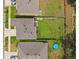 Backyard aerial view with green lawn, blue kiddie pool, patio, and privacy fence at 33657 Field Maple Loop, Wesley Chapel, FL 33545