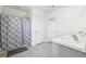 Bathroom with a floral shower curtain, a double-door closet, and a sink with a marble-look countertop at 33657 Field Maple Loop, Wesley Chapel, FL 33545