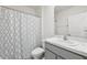 Bathroom with a white and blue patterned shower curtain and marble-look vanity top at 33657 Field Maple Loop, Wesley Chapel, FL 33545