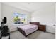 Cozy bedroom with a large window offering natural light and a view of the neighborhood at 33657 Field Maple Loop, Wesley Chapel, FL 33545