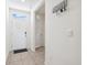 Welcoming entryway featuring neutral tile floors, white walls, and a charming 'Home Sweet Home' key holder at 33657 Field Maple Loop, Wesley Chapel, FL 33545