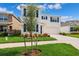 Two-story home with blue shutters, tidy landscaping and a well-manicured green lawn at 33657 Field Maple Loop, Wesley Chapel, FL 33545