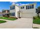 Charming two-story home with blue shutters, white walls, a two-car garage, and well manicured landscaping at 33657 Field Maple Loop, Wesley Chapel, FL 33545