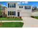 Charming two-story home with blue shutters, white walls, a two-car garage, and well manicured landscaping at 33657 Field Maple Loop, Wesley Chapel, FL 33545
