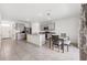 Bright kitchen features a large island with granite countertops, stainless steel appliances, gray cabinets, and tile flooring at 33657 Field Maple Loop, Wesley Chapel, FL 33545
