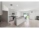 Bright kitchen features a large island with granite countertops, stainless steel appliances, and tile flooring at 33657 Field Maple Loop, Wesley Chapel, FL 33545