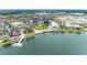 Scenic aerial view of community with lake, boardwalk, and modern shops and apartments at 3682 Johnstown St, North Port, FL 34288