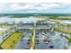 Extensive aerial view of the building, showing parking, surrounding areas, and a serene lake at 3682 Johnstown St, North Port, FL 34288