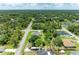 Aerial view of the property showcasing the lush green surroundings, the neighborhood, and convenient road access at 3682 Johnstown St, North Port, FL 34288