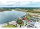 Aerial view features lakeshore attractions with lake, park, boardwalk, dining and shopping areas at 3682 Johnstown St, North Port, FL 34288