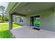 Outdoor back porch featuring a sliding glass door entry to the home, and a neutral color scheme at 3682 Johnstown St, North Port, FL 34288