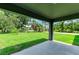 A covered back porch space with a view of the green yard, creating an inviting outdoor extension to the home at 3682 Johnstown St, North Port, FL 34288