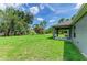View of the back yard featuring a well-manicured lawn, offering a serene outdoor space for leisure and recreation at 3682 Johnstown St, North Port, FL 34288