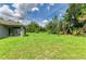 Expansive back yard of the home with lush green grass, offering ample space for outdoor activities at 3682 Johnstown St, North Port, FL 34288