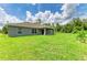 Well-maintained home exterior featuring a large green lawn, providing a picturesque setting and outdoor space at 3682 Johnstown St, North Port, FL 34288
