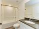 Well-lit bathroom featuring a granite countertop and a shower-tub combination at 3682 Johnstown St, North Port, FL 34288