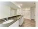 Bathroom boasts a dual vanity with granite countertops and a large mirror, plus a walk-in shower at 3682 Johnstown St, North Port, FL 34288