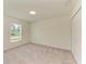 Carpeted bedroom features double door closet and natural light from window at 3682 Johnstown St, North Port, FL 34288