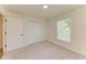 Sunlit bedroom featuring a double door closet and a large window at 3682 Johnstown St, North Port, FL 34288