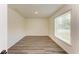 Bedroom with wood-look floors and a window offering natural light at 3682 Johnstown St, North Port, FL 34288