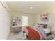Cozy bedroom showcases a desk and chair by the window and double door closet and a fun decor theme at 3682 Johnstown St, North Port, FL 34288