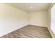 Bedroom with wood-look floors and a window offering natural light at 3682 Johnstown St, North Port, FL 34288