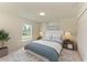 Bedroom showcasing bed, nightstands, and decorative artwork for staging purposes at 3682 Johnstown St, North Port, FL 34288
