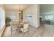 An elegant dining room with a bright window and a decorative rug under the table at 3682 Johnstown St, North Port, FL 34288