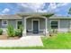 Charming front exterior with manicured lawn, flowerbeds, and a covered entryway creating a welcoming curb appeal at 3682 Johnstown St, North Port, FL 34288