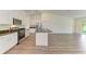 Modern kitchen with stainless steel appliances and granite countertops; open to living area at 3682 Johnstown St, North Port, FL 34288