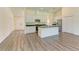 Bright kitchen showcasing white cabinets, stainless appliances, and a kitchen island with a granite countertop at 3682 Johnstown St, North Port, FL 34288