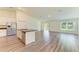 Open floor plan featuring a kitchen island with a stainless steel dishwasher and sink at 3682 Johnstown St, North Port, FL 34288