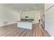 Modern kitchen featuring white cabinets, an island with a black countertop, and stainless steel appliances at 3682 Johnstown St, North Port, FL 34288