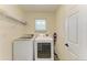 Well-lit laundry room featuring a washer, dryer, storage shelves, and a convenient floor-to-ceiling storage unit at 3682 Johnstown St, North Port, FL 34288