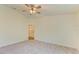 Spacious main bedroom features neutral carpeting, a ceiling fan, and an ensuite bathroom at 3682 Johnstown St, North Port, FL 34288