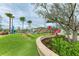 Community playground with climbing structures, turf hills, and mature landscaping for Gathering fun at 3682 Johnstown St, North Port, FL 34288