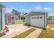Backyard showcasing detached garage, light-green house, stairs, and concrete and brick trim at 3940 Miramar S Way, St Petersburg, FL 33705
