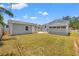 Expansive backyard featuring a grassy lawn and two charming outbuildings, perfect for outdoor activities at 3940 Miramar S Way, St Petersburg, FL 33705