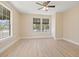 Spacious bedroom with light wood floors, two large windows, closet, and neutral paint at 3940 Miramar S Way, St Petersburg, FL 33705