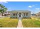 Charming single-story home featuring a well-manicured lawn, white picket fence, and light-blue exterior at 3940 Miramar S Way, St Petersburg, FL 33705