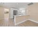 Open concept kitchen with white cabinetry, stainless steel refrigerator and granite countertops at 3940 Miramar S Way, St Petersburg, FL 33705