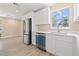 Kitchen features stainless steel appliances and white cabinets with a new dishwasher at 3940 Miramar S Way, St Petersburg, FL 33705
