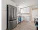 Kitchen features stainless steel appliances and white cabinets with a new dishwasher at 3940 Miramar S Way, St Petersburg, FL 33705