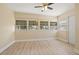 Sunroom/Living room with four windows, ceiling fan and neutral paint and baseboards at 3940 Miramar S Way, St Petersburg, FL 33705